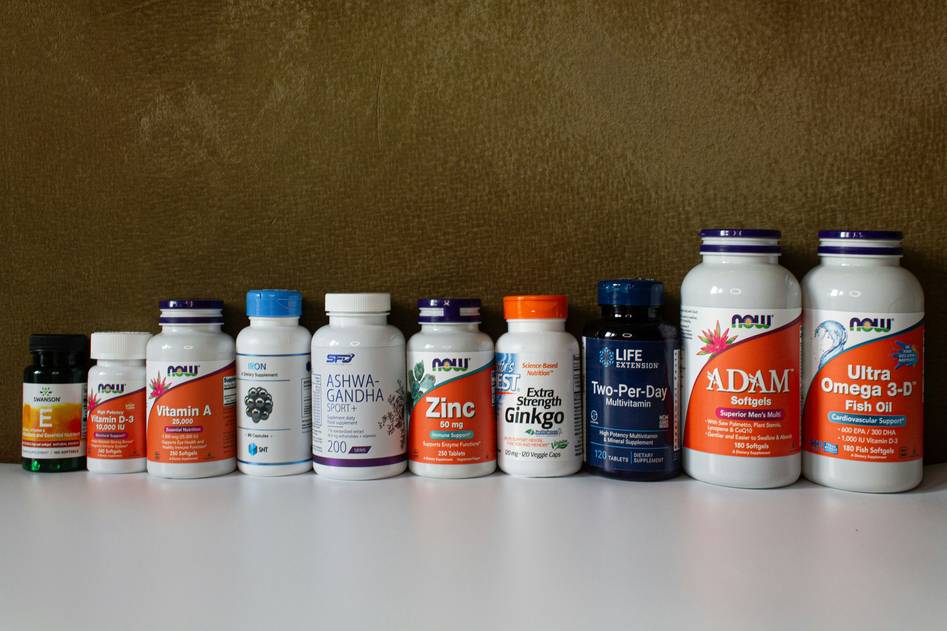 Elegant anti-aging supplement bottles with natural botanicals on marble
